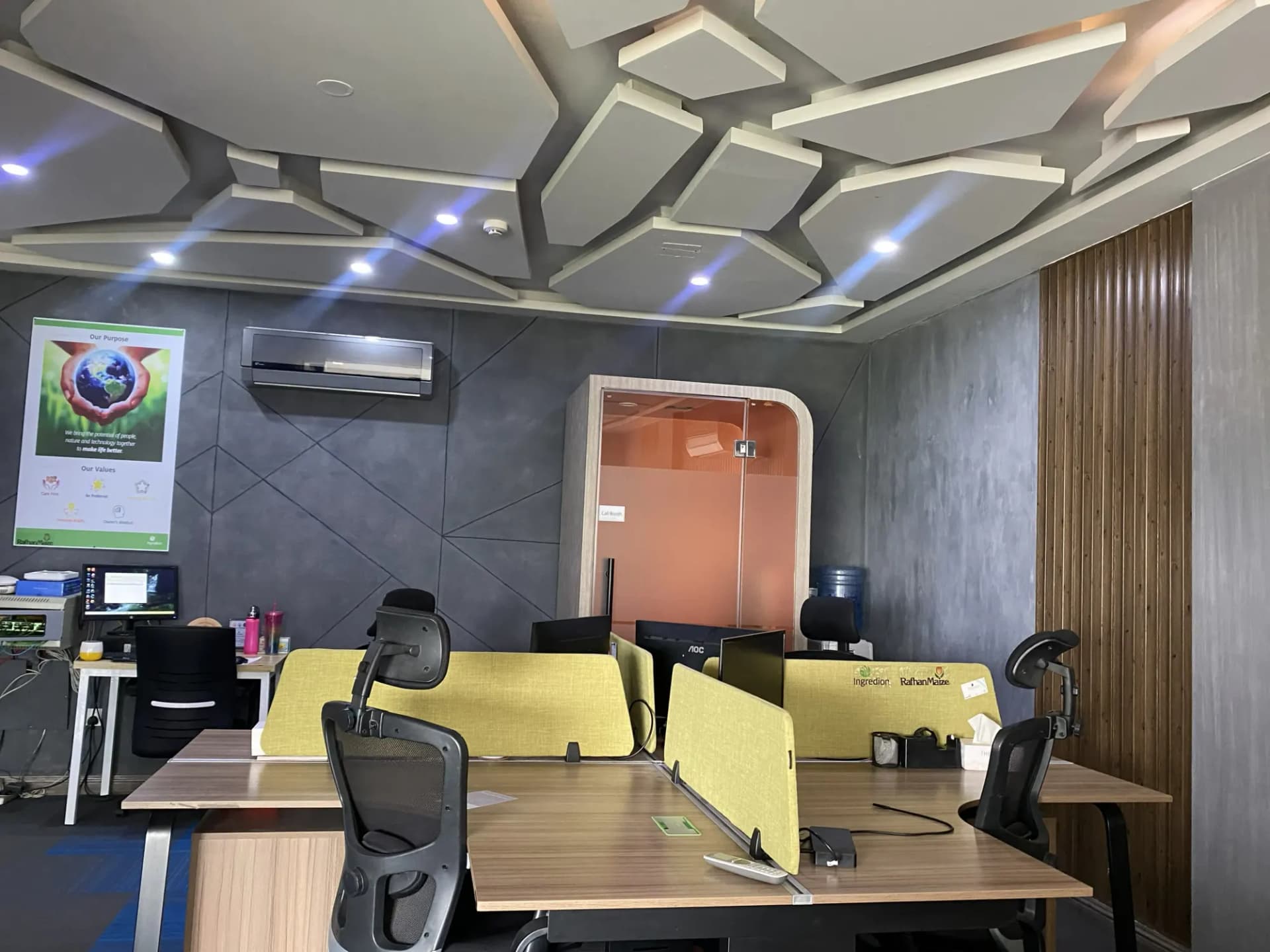 Coworking floor at The Hive Lahore under a sculpted geometric ceiling