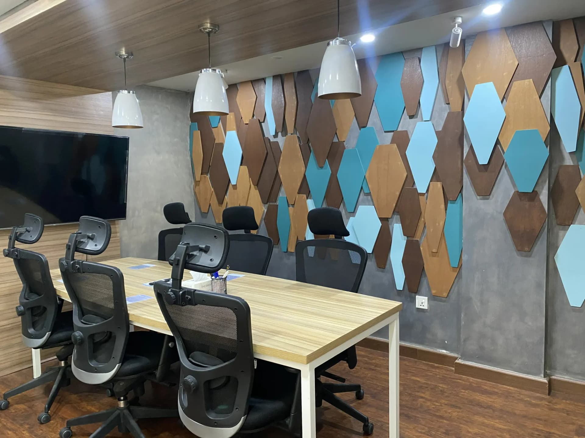 Meeting area at The Hive Lahore with a hexagon acoustic feature wall